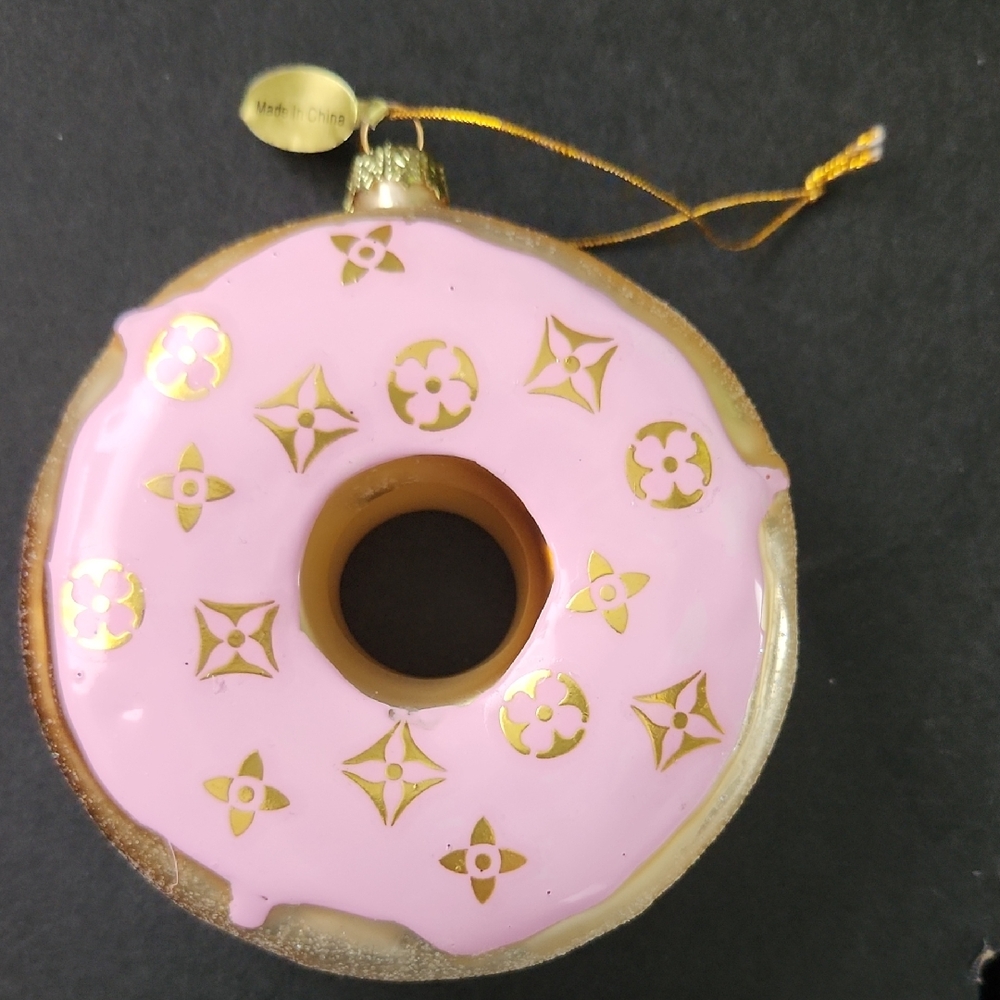 Gold Donut Ornament with Designer Gold Logo Accents On Pink Icing